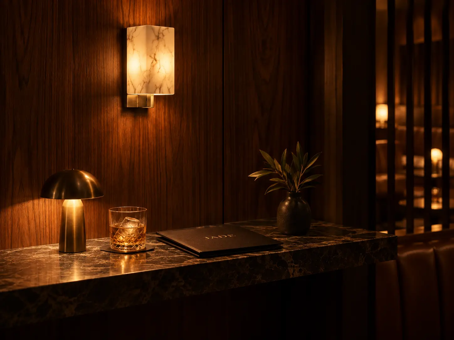 JADE host stand beneath warm marble and brass lighting